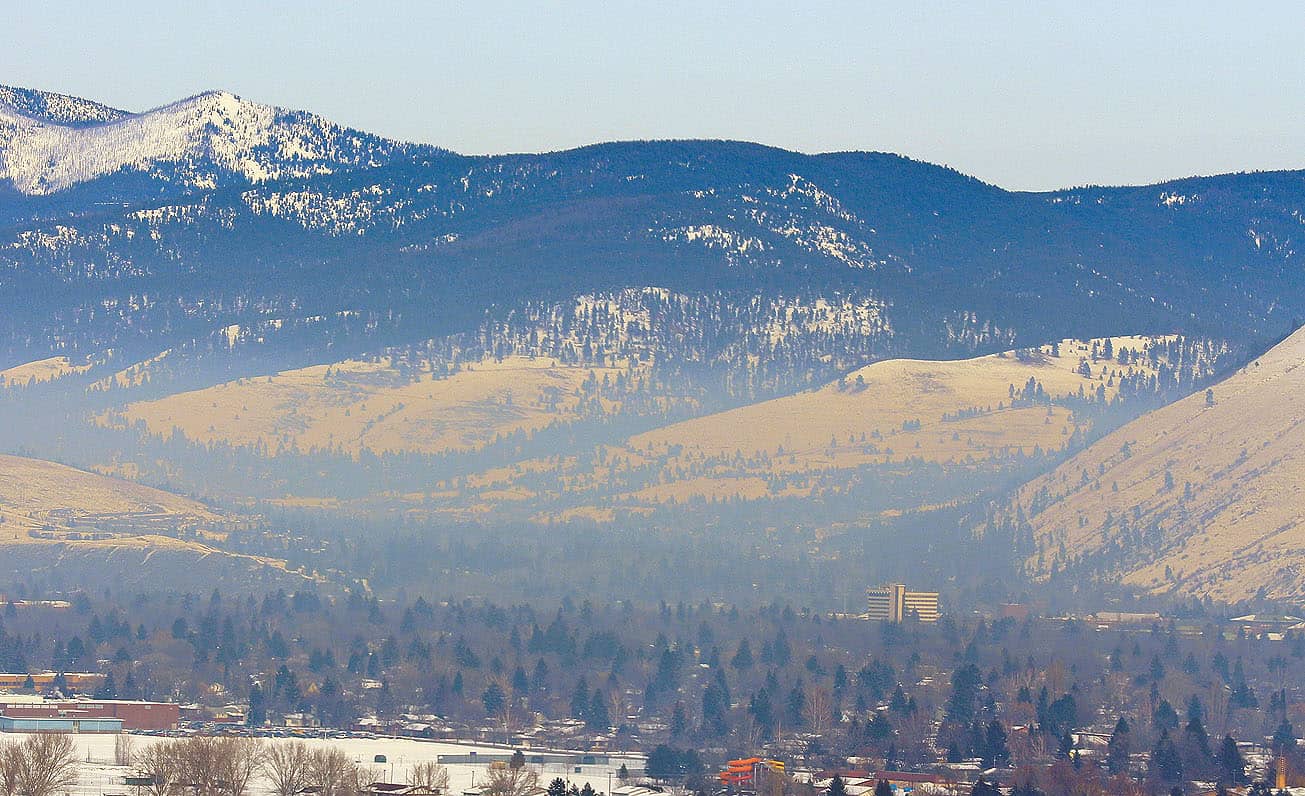 Breath Deeply? The Missoula Valley has some of the worst air quality in the country.  Pictured here is a view of the University and downtown area from a Stage 2 air pollution warning day in January 2013. Photo by Chad Harder.