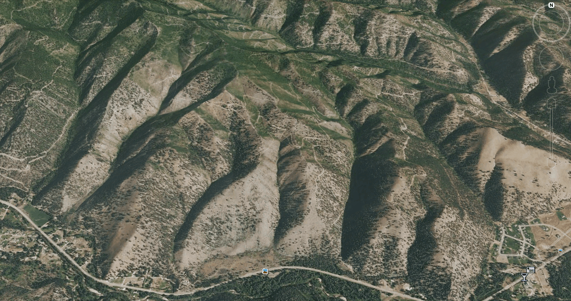 Google Earth image showing a pre-fire portion of the landscape now burning as part of the Lolo Creek Complex, currently the nation's number 1 priority fire.  For orientation purposes, the picture icon on the middle-bottom of the image is "Fort Fizzle" (a temporary military post erected in July 1877 by the U.S. Government to intercept the Nez Perce Indians [including women and children] in their flight from Idaho across the Lolo Pass into the Bitterroot Valley....and eventually to the Big Hole, Yellowstone and then all the way up to Canada).    The road at the bottom of the image is US Hwy 12 and you'll notice a fair number of homes and neighborhoods scattered along the highway.  The two other pictures in this post (below) were taken near Hwy 12 and are looking to the north on the slopes above Fort Fizzle.   According to a property ownership search on the official State of Montana site, nearly all of the land in this image north and above the highway is owned by Plum Creek Timber Company, although 3/4 of a section is owned by "YT Timber" out of Townsend, MT (likely connected to RY Timber in Townsend) and nearly 1/2 a section is owned by "BFP Partnership" from Missoula (which appears to be a development company).   If we could turn back the clock to pre-Lolo Creek Complex what specific land management activities would you recommend in this landscape in terms of restoring the forest, addressing "fuels" or protecting the homes and neighborhoods from the inevitability of wildfire?