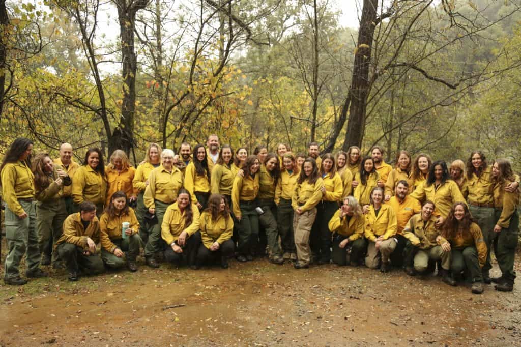 Despite the rain, participants in the first female wildfire training program gather outside to take a group photo at a Whiskeytown training camp on Oct. 27. (Tauhid Chappell/The Washington Post)