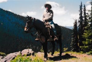 Mounted wilderness ranger and packer Jim Leep on mule. 